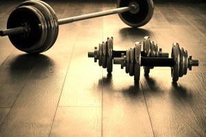 dumbells for fitness on wooden floor with empty space